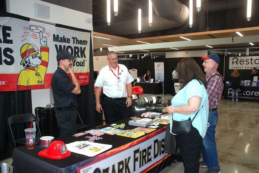 Firefighters from the Ozark Fire Protection District talk with Showcase Ozark attendees.