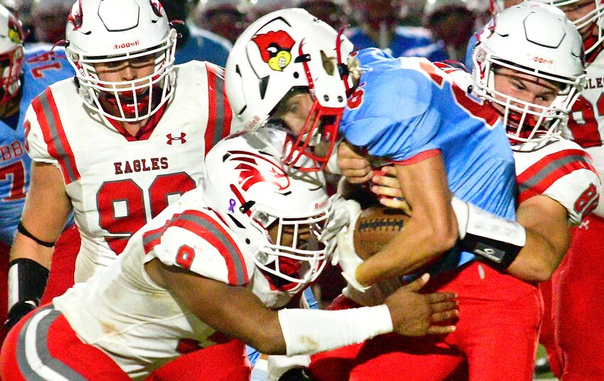 NIXA LINEBACKERS TOBIAS THOMPSON AND JACOB GRIMM team up for a tackle at Webb City.