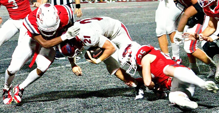 NIXA'S TOBIAS THOMPSON AND TY KELLIS combine for a tackle versus Joplin last week.