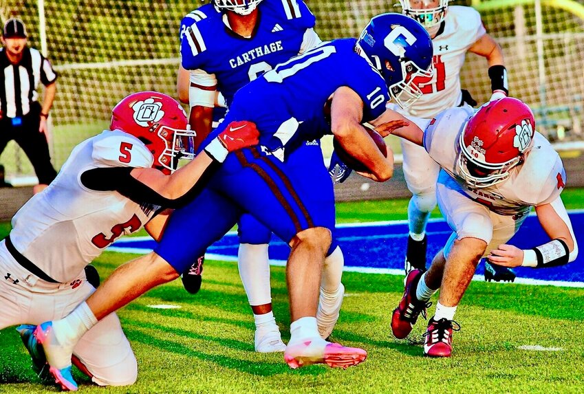 OZARK'S SAM SAVICH AND JORDAN GILES team up for a tackle at Carthage in Week Three.