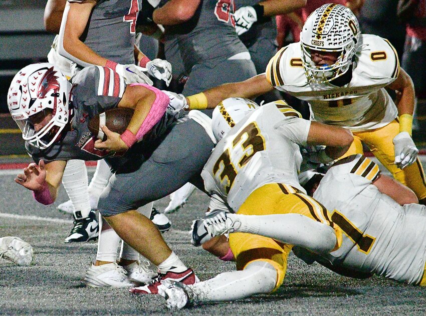 NIXA'S DYLAN REBURA breaks through the Kickapoo defensive line.