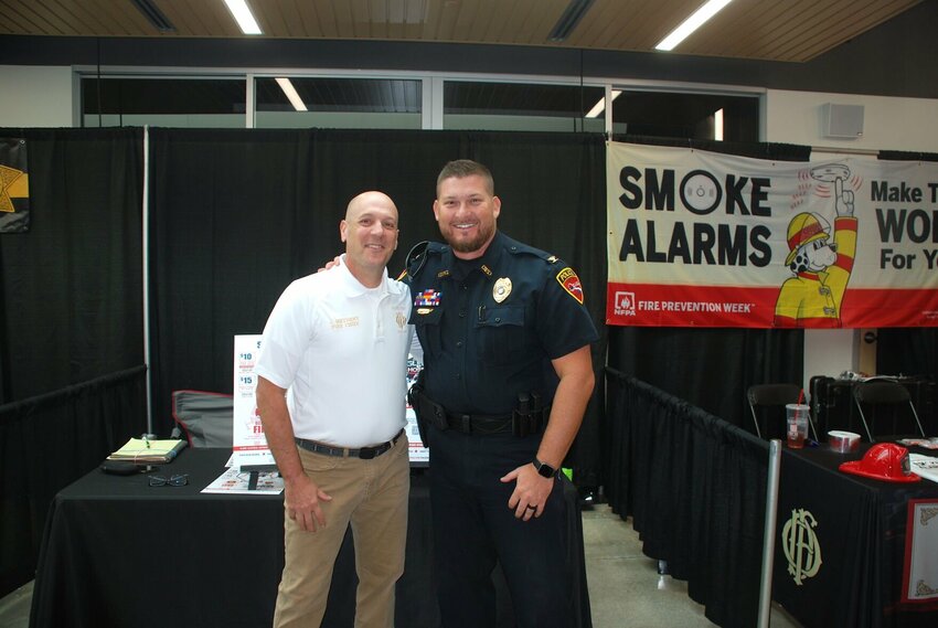 Ozark Fire Chief Jarett Metheny (left) and Ozark Police Chief Justin Arnold at last month’s Showcase Ozark Expo. The Ozark Fire Protection District and the Ozark Police Department will go head-to-head in the inaugural Ozark Guns and Hoses Charity Softball Game on Saturday, Oct. 12, 2024.