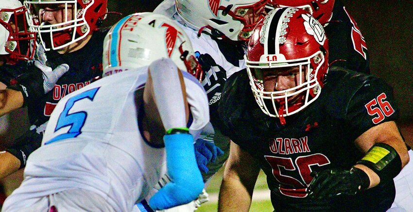 OZARK'S COLIN COOK gets set to block a Glendale defender.