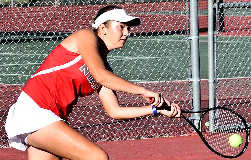 NIXA'S EMILY PETERSON reaches for a backhand return.