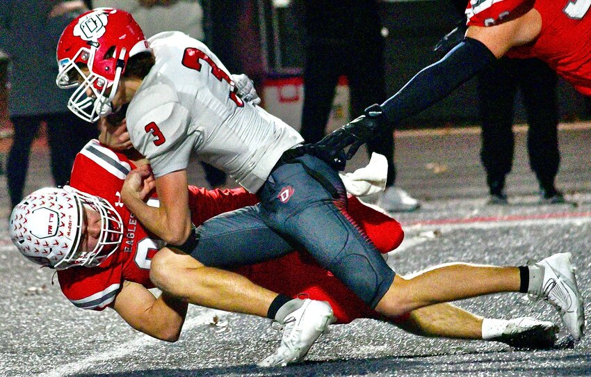 NIXA'S JACOB GRIMM brings Ozark's Peyton Russell to the turf.