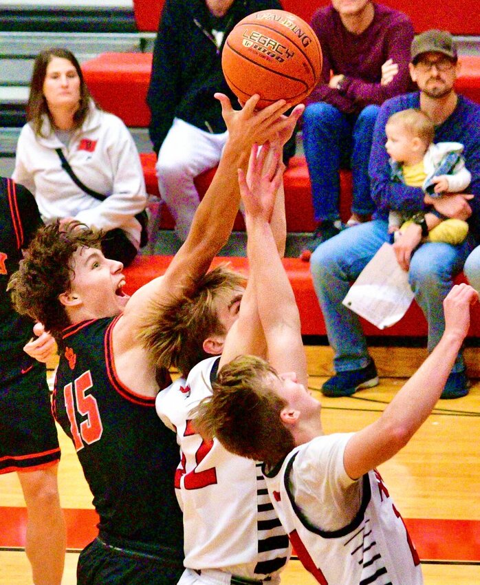 OZARK'S HUDSON ROBERTS reaches for a rebound at Branson last week.