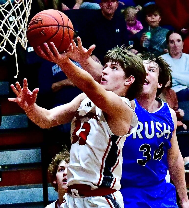CHADWICK'S CLAYTON GARRISON beats a RUSH defender to the hoop for a left-handed layup.