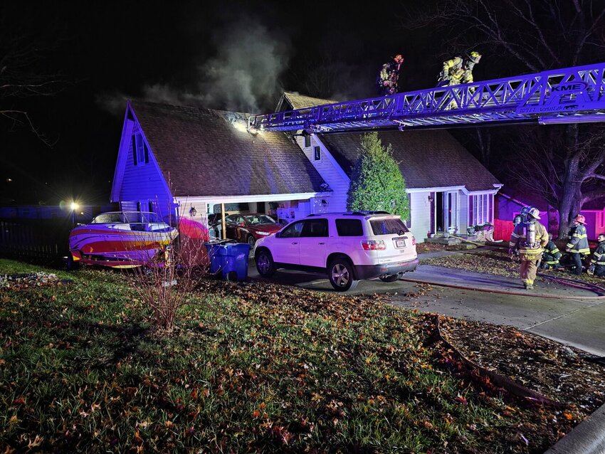Firefighters put out the fire at a house in Ozark on Christmas Eve. After the fire, members of the community came out to assist the family who lived at the residence. Picture submitted by Aaron Heaton.