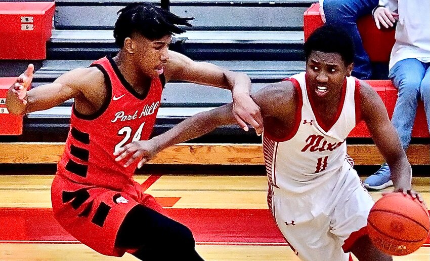 NIXA'S JAISE COMBS dribbles under pressure.
