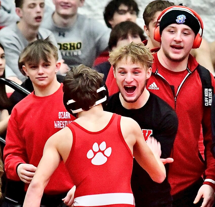 OZARK'S GRAYSON CLEVENGER is greeted by Keaton Hurst after earning a berth to State.