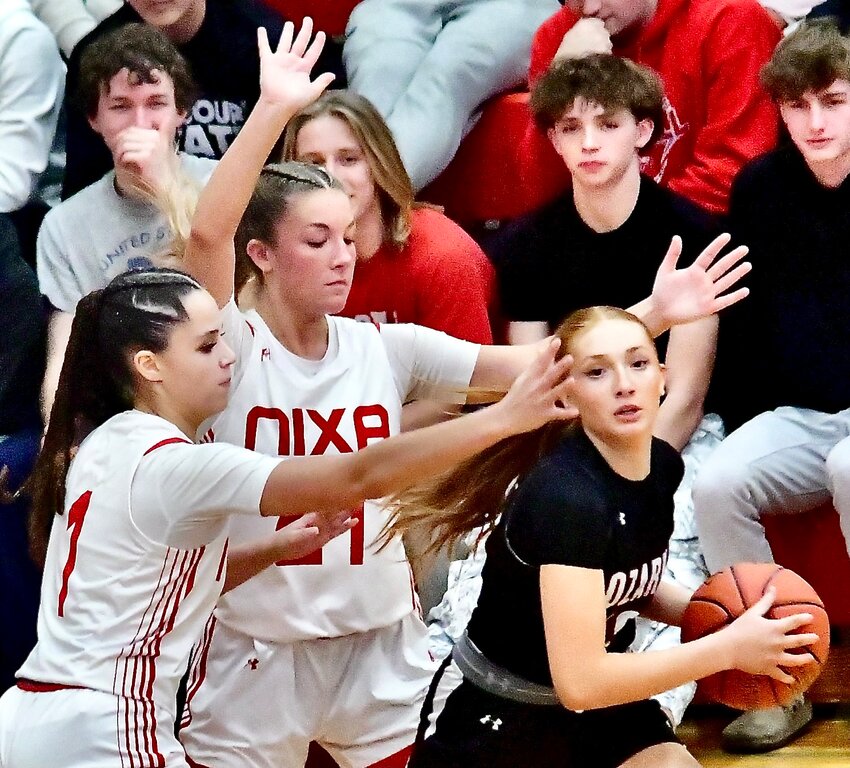 OZARK'S MAGGIE SULT finds herself trapped by Nixa's Addi Ruffin and Kennedy Nash on Monday.