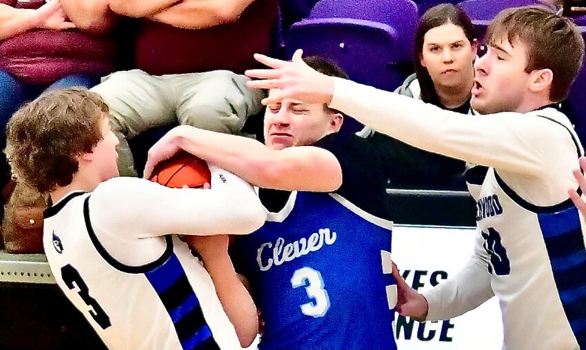 CLEVER'S LUCAS PEEBLES tries to maintain possession of the ball while trapped by a pair of Greenwood defenders Wednesday.