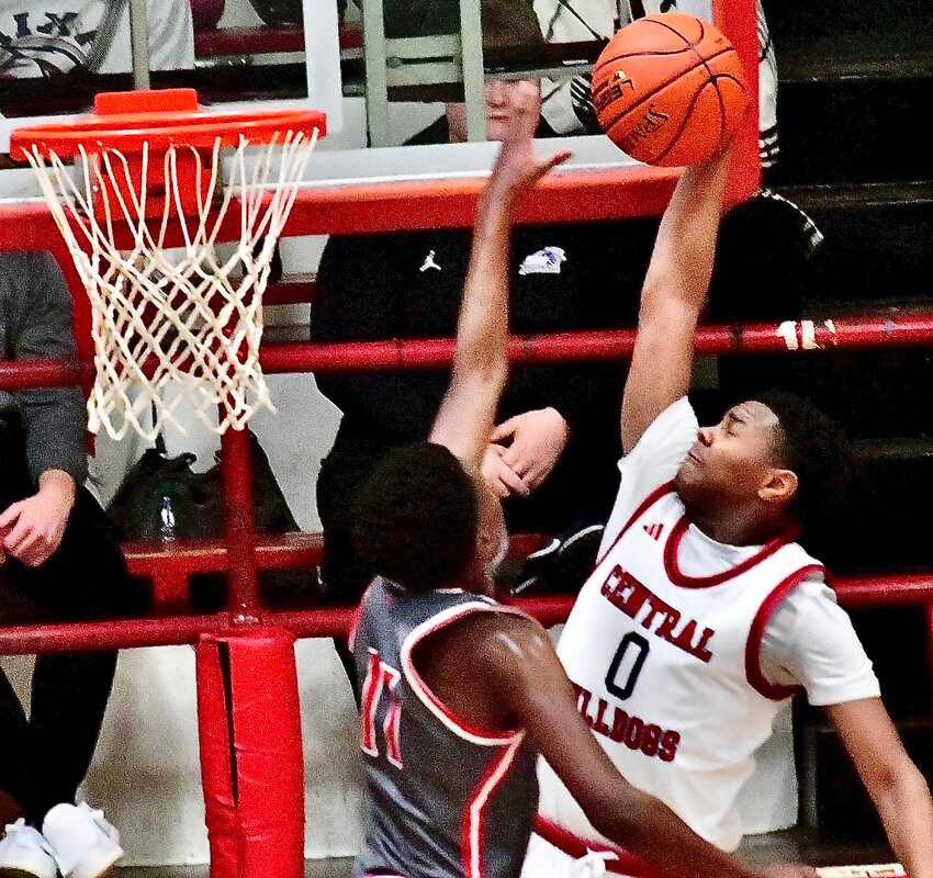 NIXA'S JAISE COMBS blocks a dunk attempt by Springfield Central's Keion Eppsl