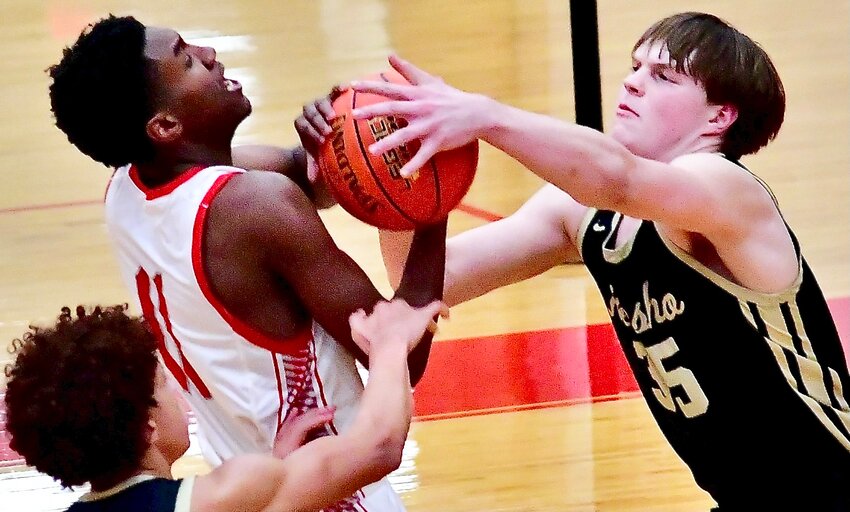 NIXA'S JAISE COMBS battles for possession of the ball with a Neosho player Wednesday.