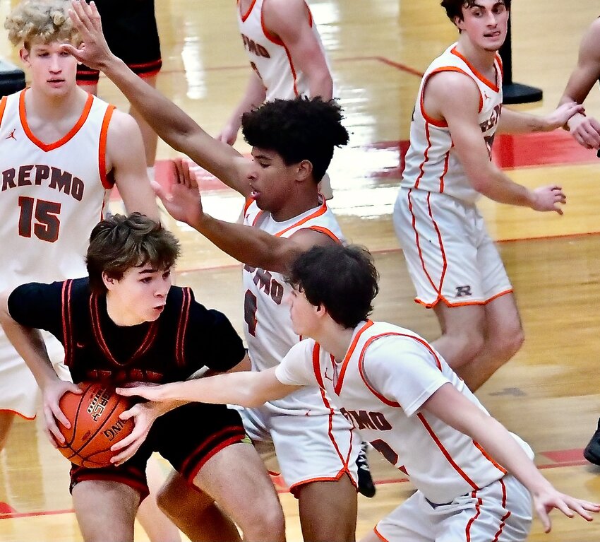 OZARK'S KYLAN PICKREN draws a trio of defenders.