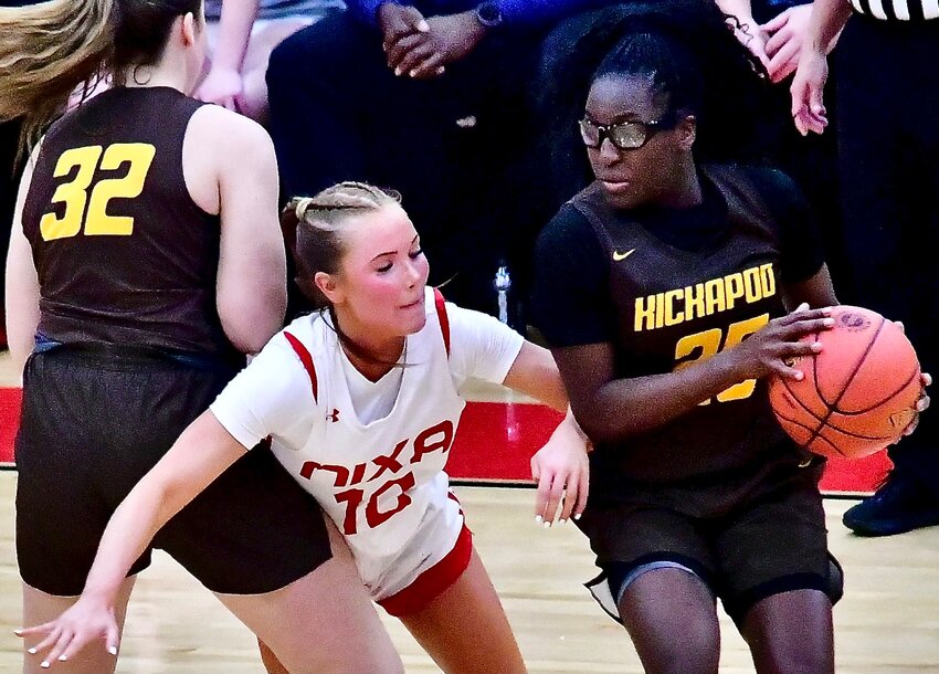 NIXA'S KARIS FERGUSON tries to get around a Kickapoo screen in the teams' Class 6 District 5 title tilt Tuesday.