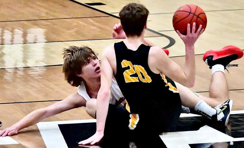 CHADWICK'S CLAYTON GARRISON hits the floor during a scrum for a loose ball against Risco.