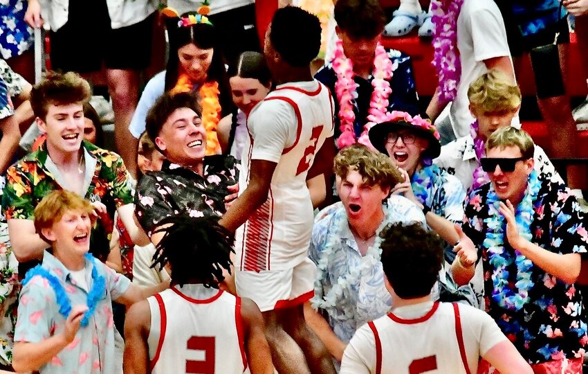 NIXA'S KEIVON FLINT jumps into the Eagles' student section in celebration of Friday's Quarterfinal triumph.