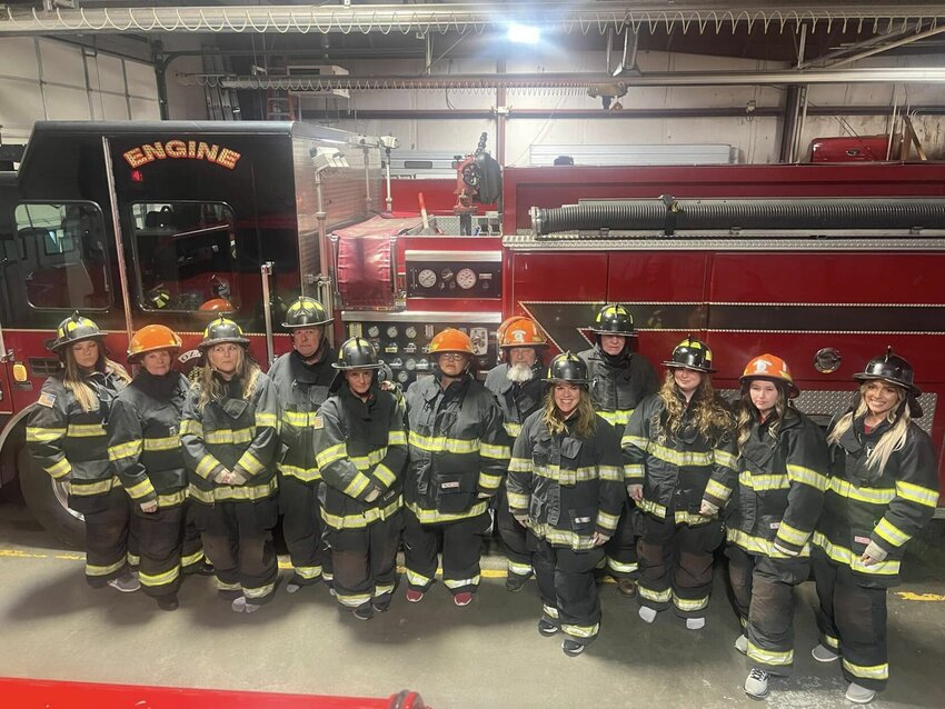 The members of the 2024 Ozark Fire Academy try on firefighting gear during one of their classes. Participants in the 2025 Ozark Fire Academy will have the opportunity to use firefighting equipment in various situations. Photo courtesy of the Ozark Fire Protection District.