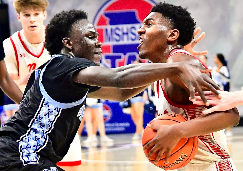 NIXA'S JAISE COMBS looks for room around an Oak Park defender Wednesday at the Class 6 Final Four.