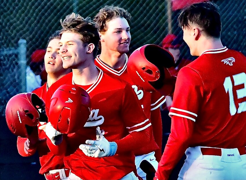 NIXA''S ADAM MCKNIGHT is all smiles after hitting a home run Friday.