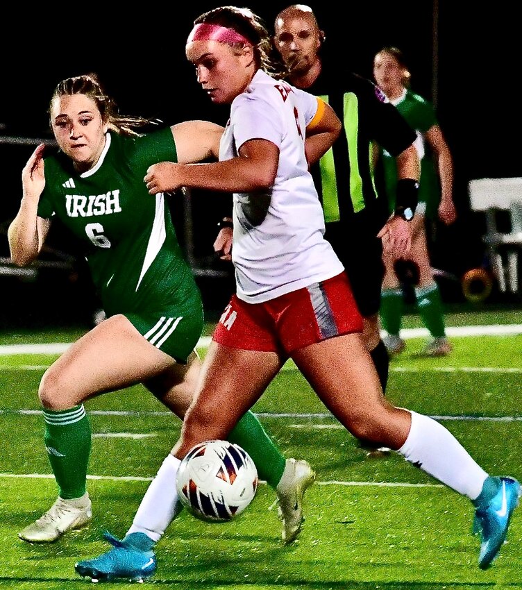 NIXA'S SAM MCCLAIN receives a pass in the Lady Eagles' season-opening win at Springfield Catholic on Tuesday.