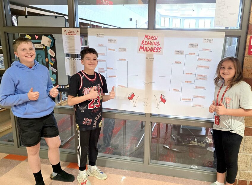 Pictured from left, Ozark Middle School students Jett Emmerton, Quinn Hayward and Cora White have enjoyed participating in the March Reading Madness competition. Photo courtesy of Ozark Public Schools.
