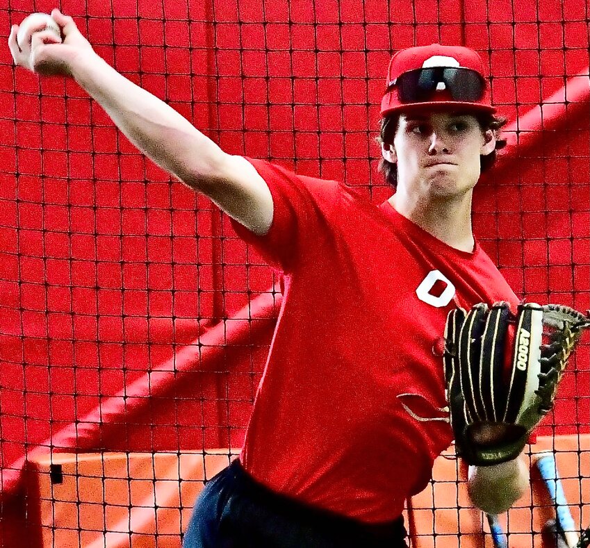OZARK'S PEYTON BULLINGER warms up his arm during a practice.