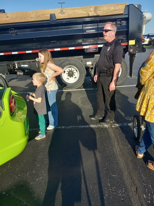 Adeline Jennings, 9, and her little brother Finley, 4, children of Alicyn Jennings, play a specially designed video game at the Nixa D.A.R.E. vehicle while Nixa D.A.R.E. Officer Brent Forgey. The vehicle was specially designed and built by Forgey. All photos by Steve Chapman.