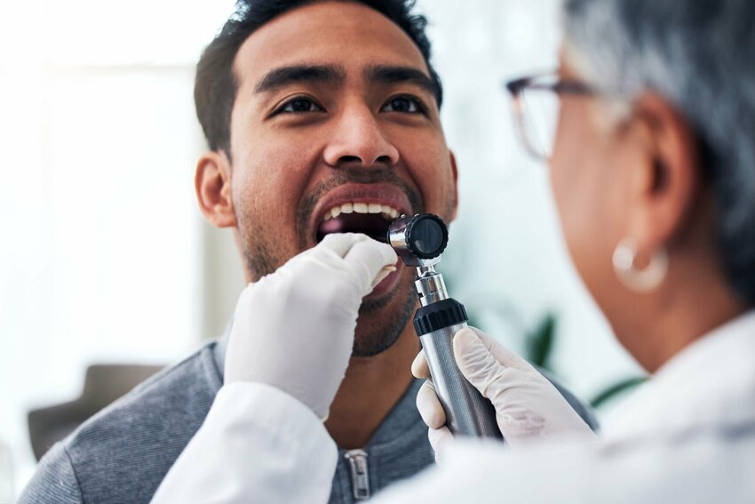 Medical, check and doctor with person and throat in hospital for cancer, sick and surgery. Medicine, healthcare and consulting with woman and patient in clinic for wellness, virus and oral exam