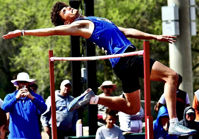 CLEVER'S XAVIER ROBINSON makes an attempt to clear the bar in the high jump.