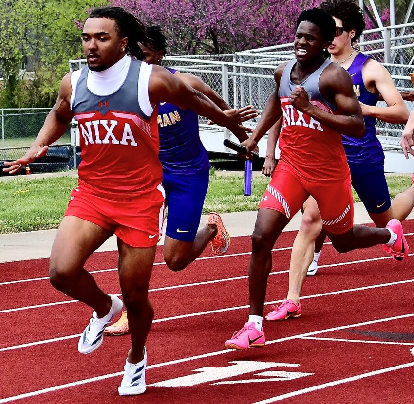 NIXA'S KEIVON FLINT, right, gets set to make a handoff to teammate Tobias Thompson.
