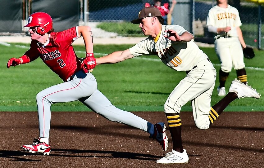 OZARK'S MARCUS HEAVIN is tagged out by a Kickapoo infielder after a rundown in between first and second Tuesday.