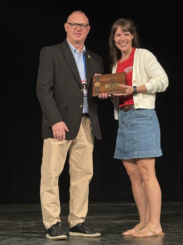 Marty Marsh from the MSHSAA presents Dr. Allison Fleetwood with the Missouri Outstanding Theatre Educator of the Year Award. Photo courtesy of Nixa Public Schools.
