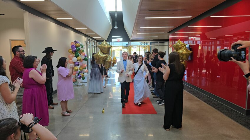 Student volunteers and parents welcome those taking part in the Spring Fling.