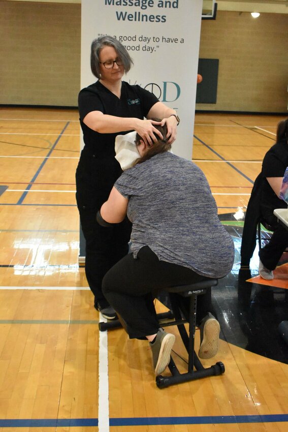Darlene Roberts, licensed massage therapist and owner of The Good Place, gives an attendee at the Health and Wellness Expo a chair massage. The Good Place was one of about 20 vendors at the expo. Photo by Steve Chapman.