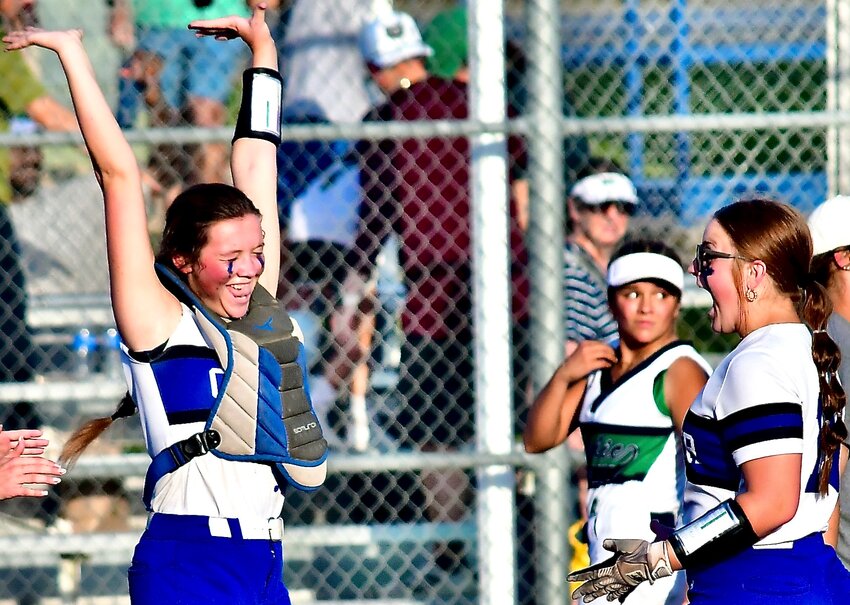 CLEVER'S PIPER STEELE raises her arms in celebration as she is met by teammate Maycee King.