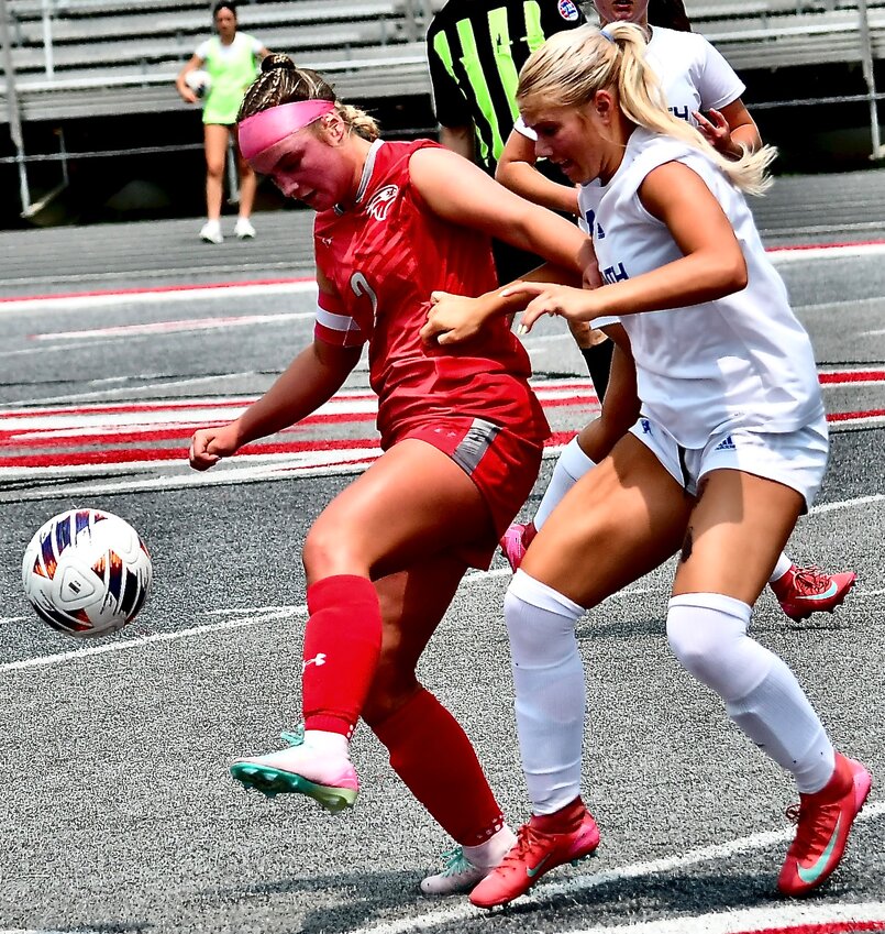 NIXA'S SAM MCCLAIN keeps herself between the ball and a Blue Springs South player.