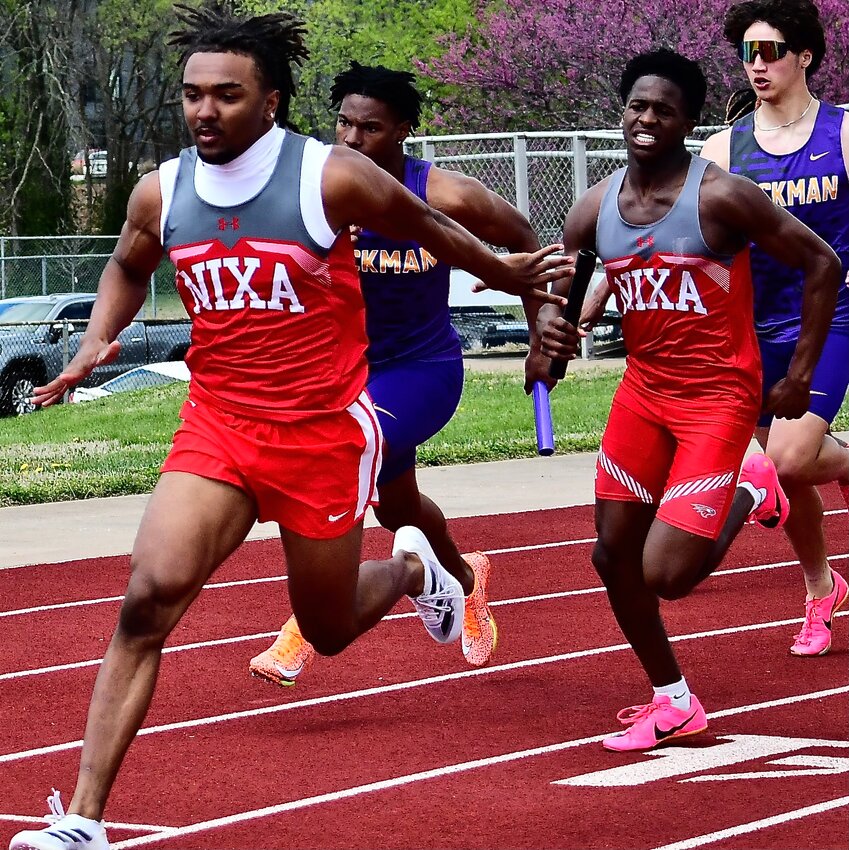 NIXA'S TOBIAS THOMPSON, left, receives a baton from Keivon Flint earlier this spring.