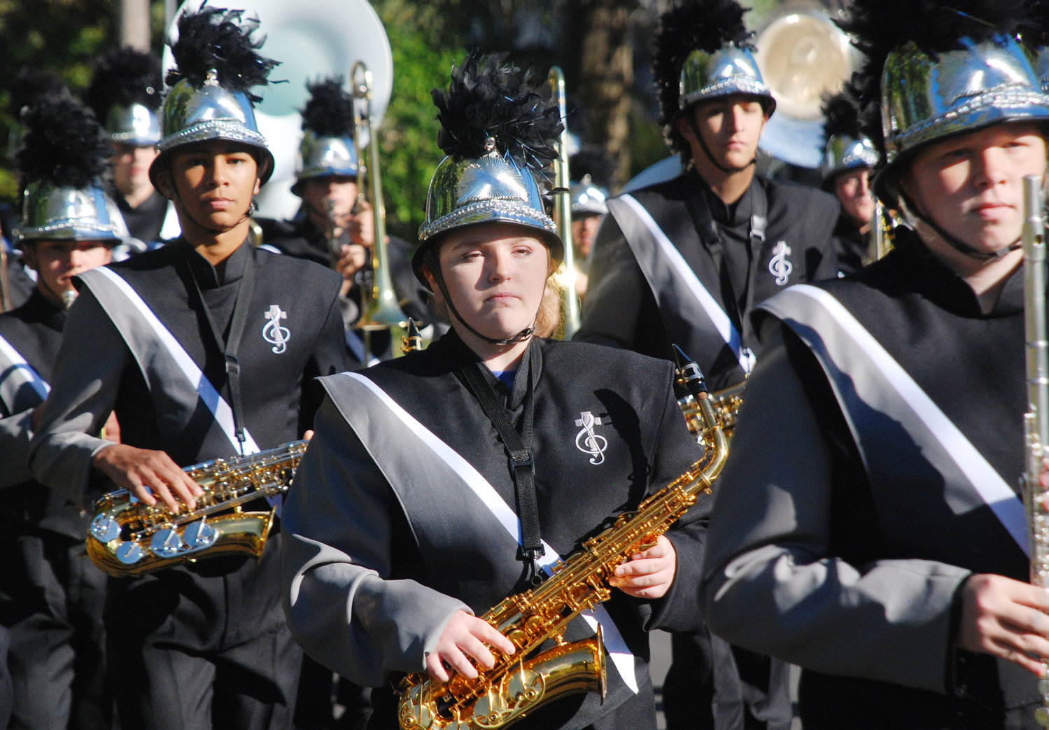 SAXOPHONE PLAYERS walk to the beat of a marching drum as the Sparta High School Marching band proceeds south along North Oak Avenue on Oct. 16.