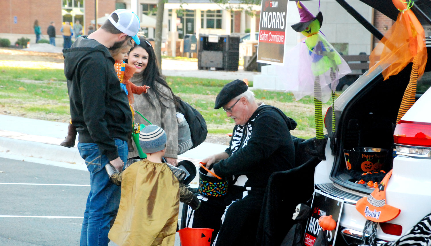 CHRISTIAN COUNTY EASTERN DISTRICT COMMISSIONER LYNN MORRIS (seated) came prepared for the Downtown Ozark Trunk Or Treat with lawn chairs and a not-so-spooky skeleton costume.