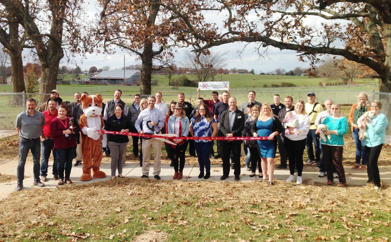 THE NIXA CHAMBER OF COMMERCE held a ceremonial ribbon cutting for the grand opening of the Nixa Dog Park on Nov. 17, 2021. Members of the Nixa Department of Parks and Recreation staff hosted business leaders from Nixa to celebrate the park’s opening.
