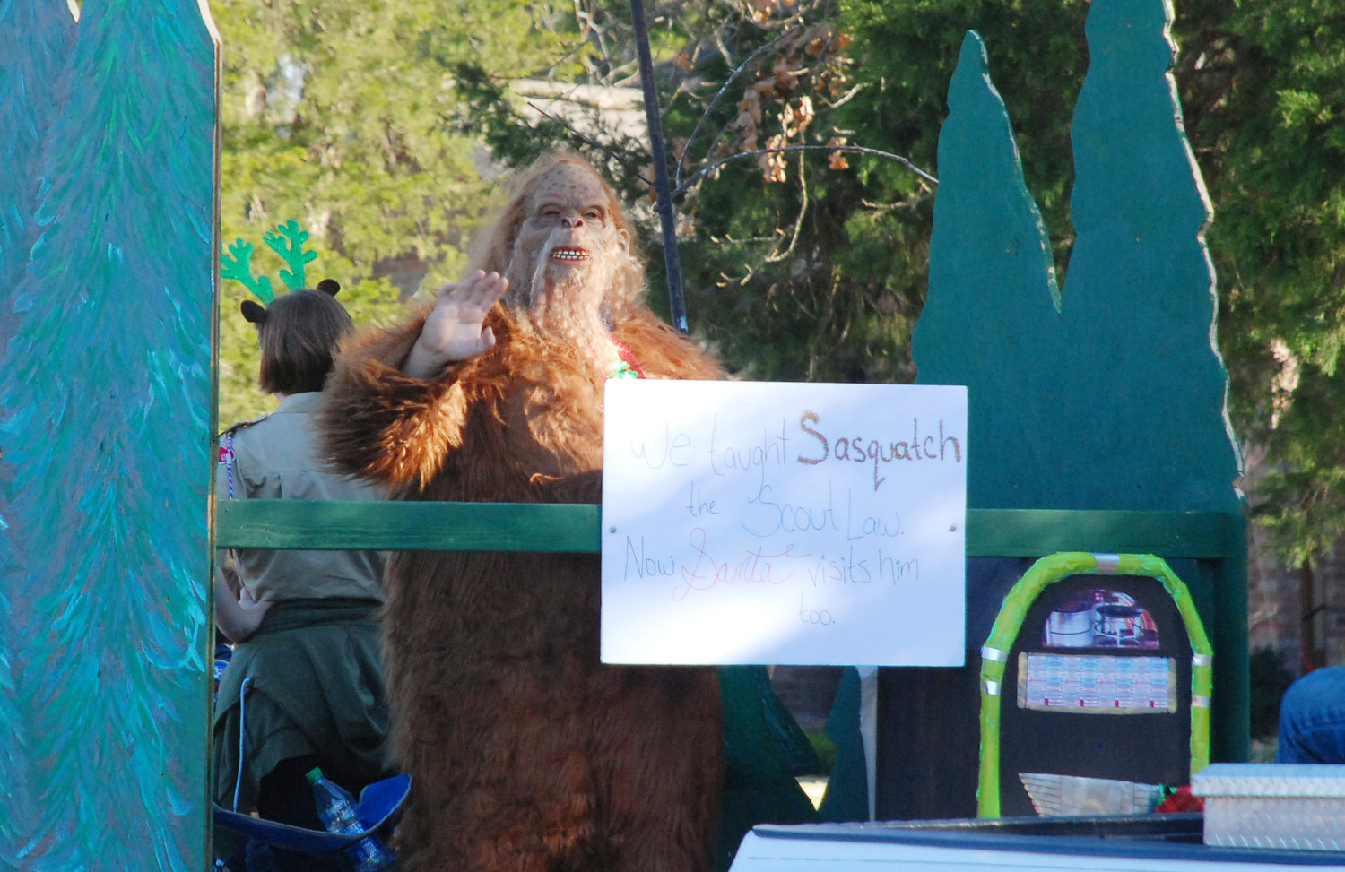 SASQUATCH made an appearance in the Nixa Christmas Parade, riding aboard a float with some boy scouts.