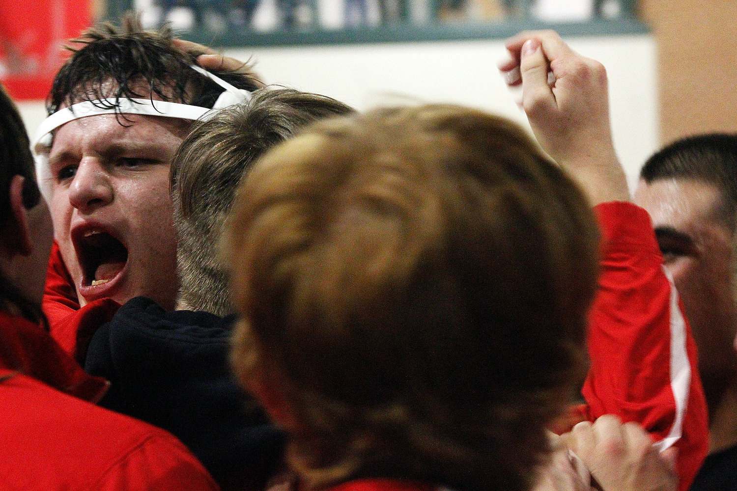 CHARLES SPEAKE is mobbed by teammates after a win at 285 pounds.