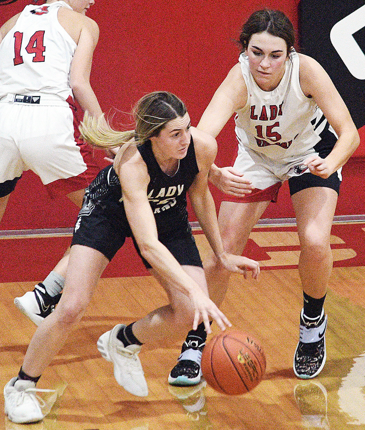 SPARTA’S SHELBY MCMURRY dribbles while defended by Chadwick’s Chloe Burkart.