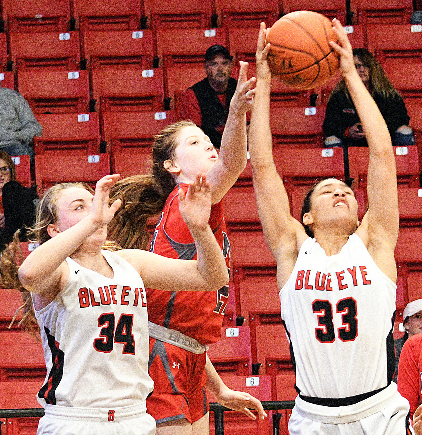 NORAH CLARK tries to grab a rebound away from a Blue Eye player.