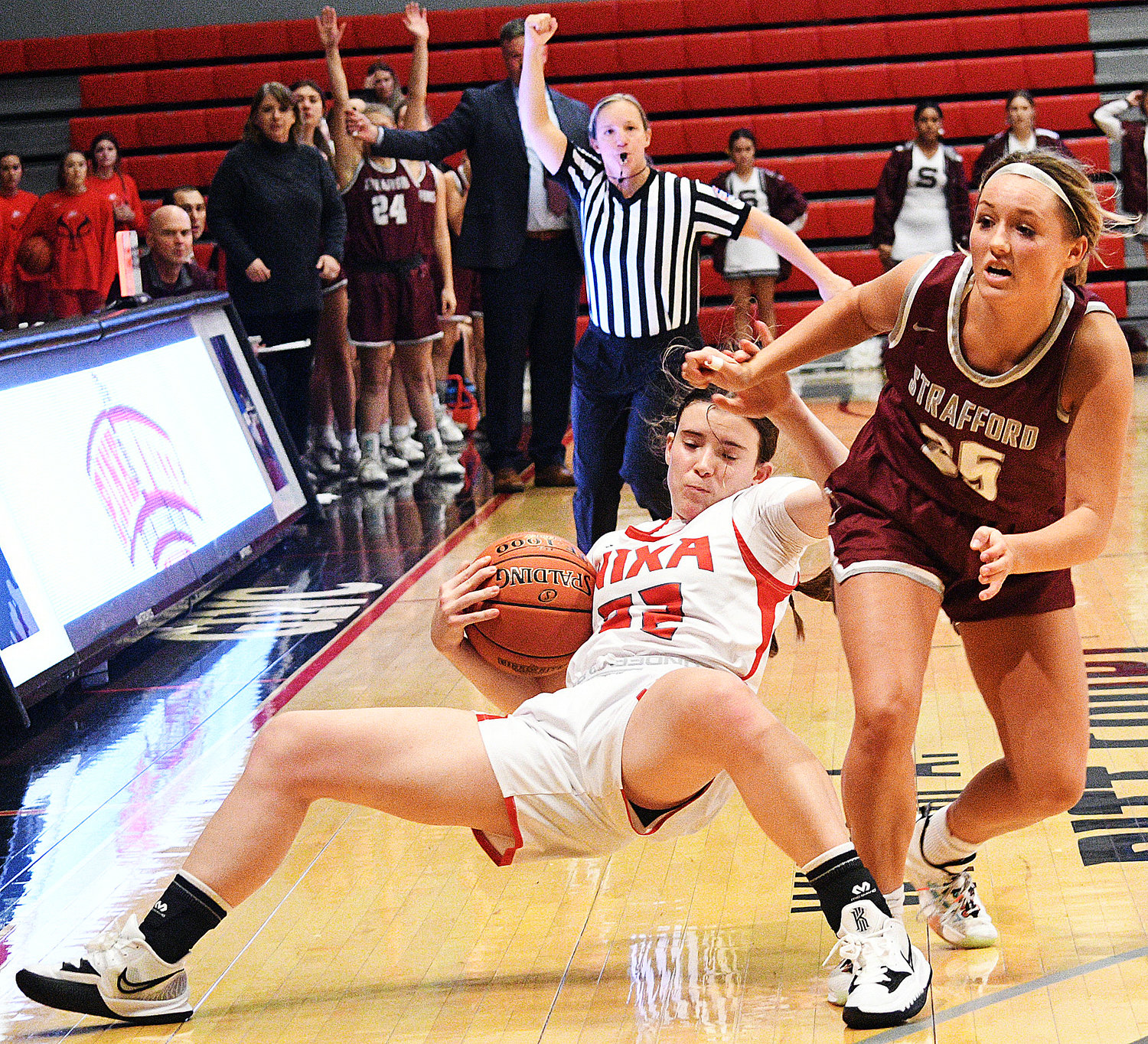 RHI GIBBONS is fouled while tracking down a loose ball.