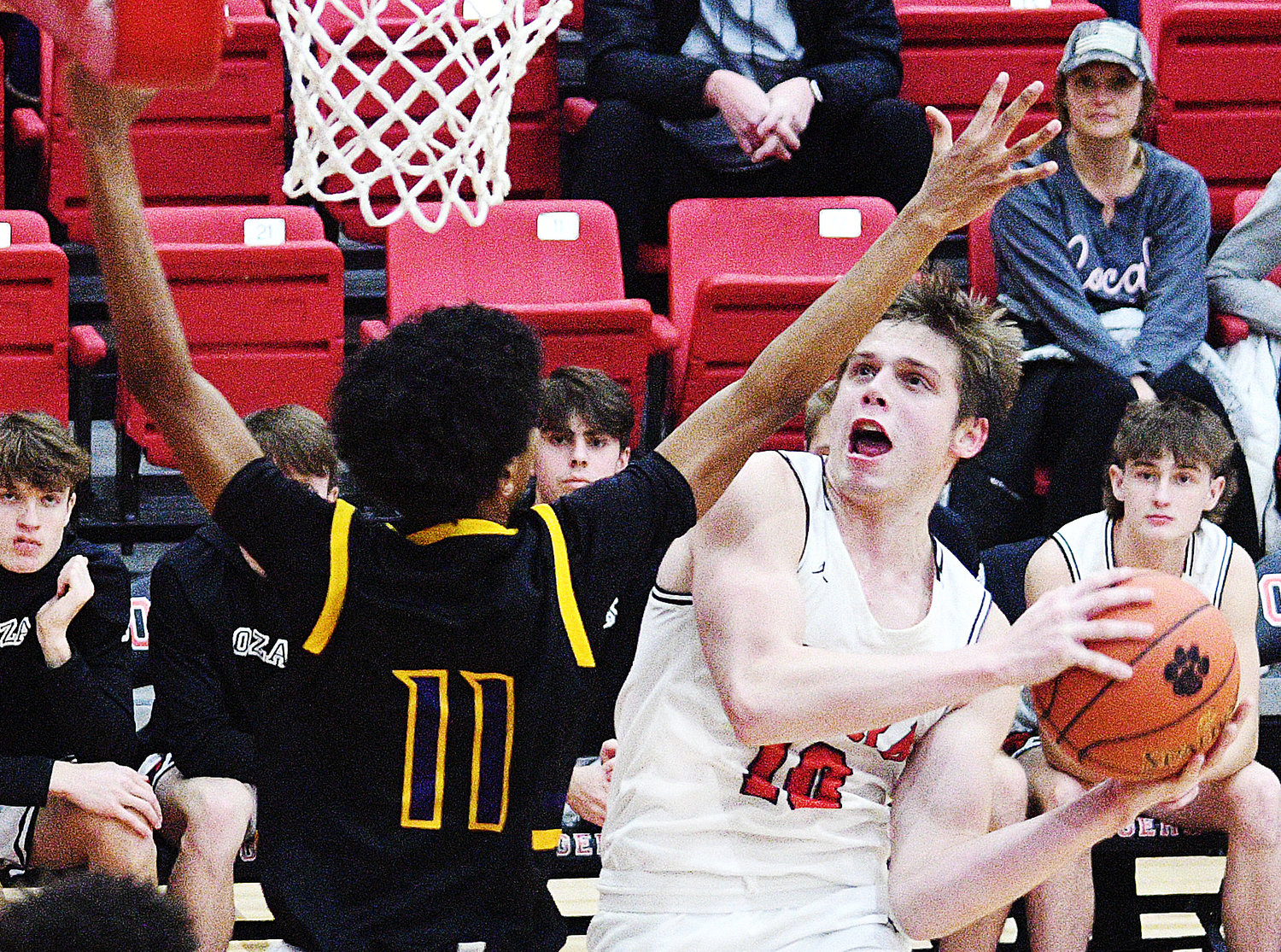 OZARK'S TYLER HARMON soars to the hoop for two of his 23 points against Columbia Hickman last week.