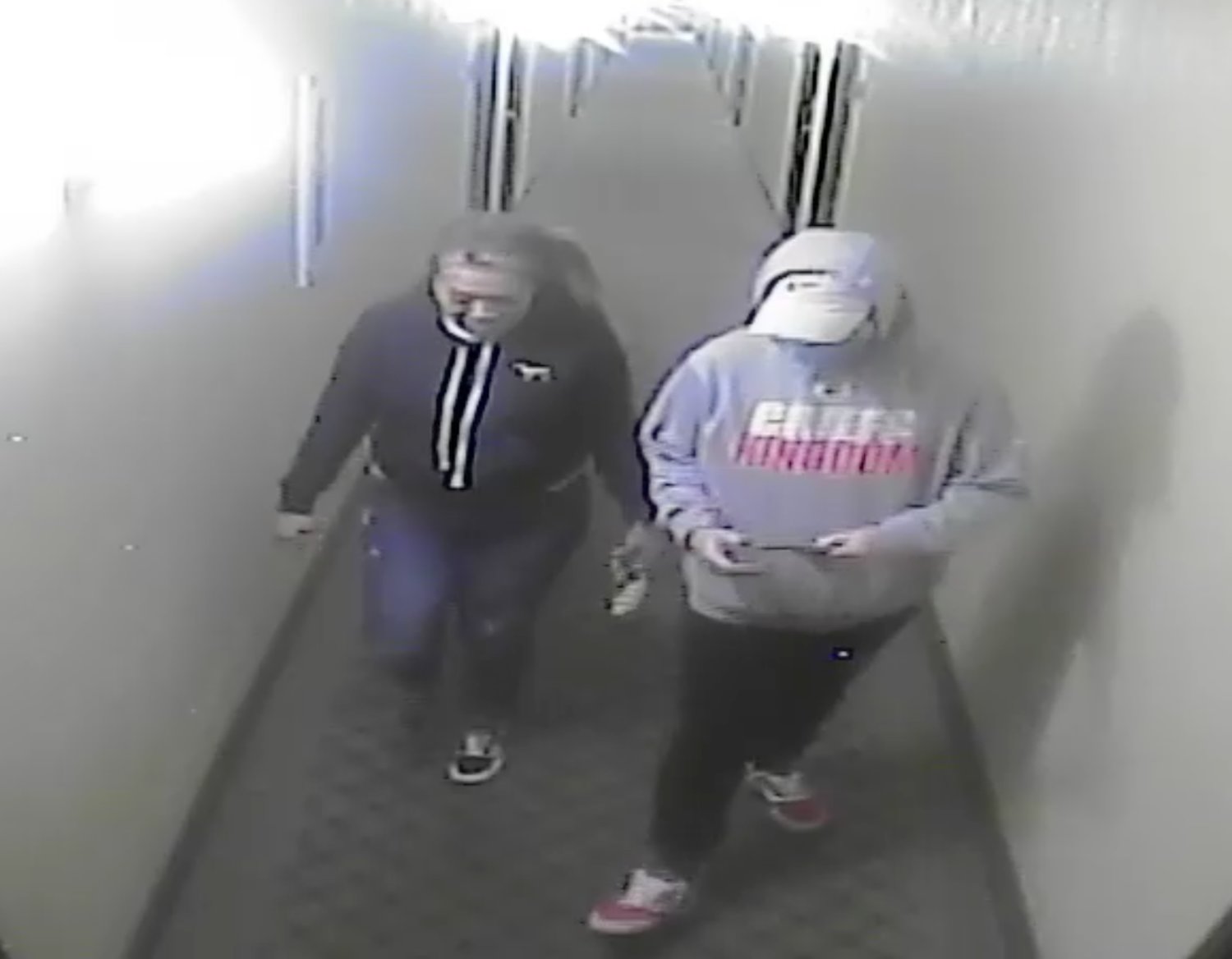 TWO SUSPECTS involved in the theft of cash in Nixa, as shown from a hallway surveillance camera at the Nixa Super 8 hotel.