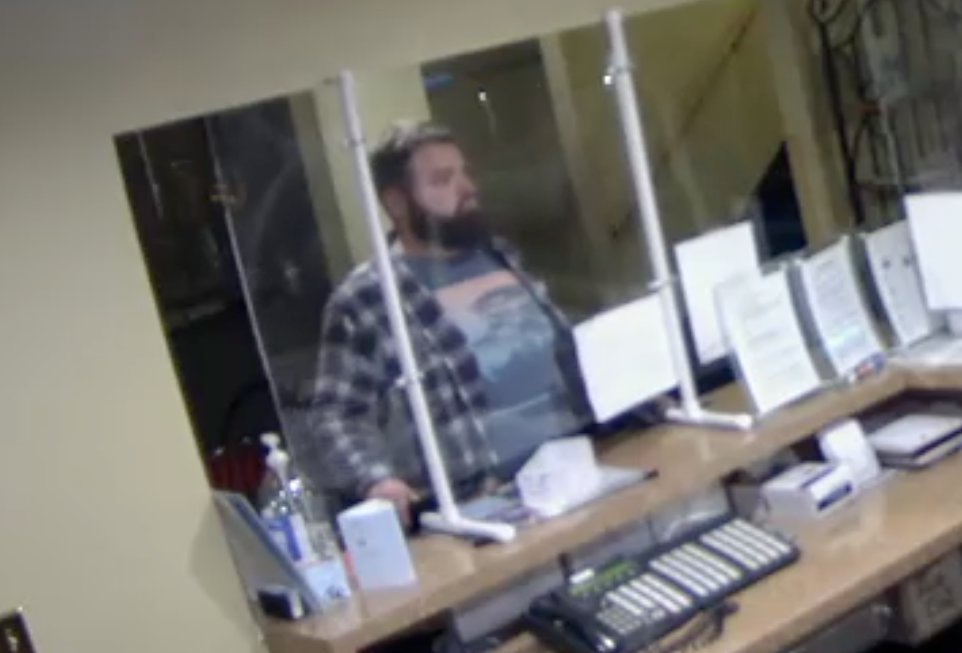 A THIRD SUSPECT shown at the front desk of the Nixa Super 8 hotel is believed to have taken an undisclosed amount of money as two accomplices distracted the hotel clerk.